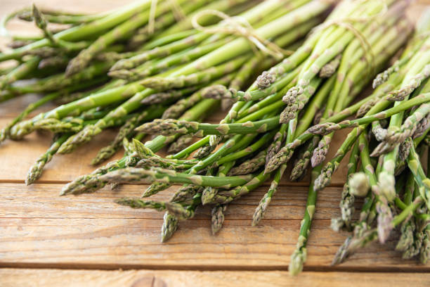 istock Bunch of raw asparagus spears, close up 1488230628