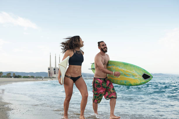 istock Happy surfers with boards on shore 1488231690