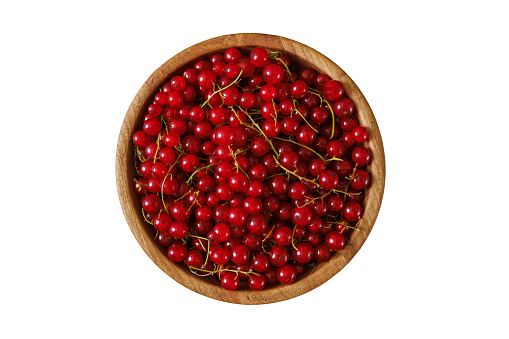 Fresh red currant in wooden bowl on dark table. Summer fruit berry. Healthy fruits and food