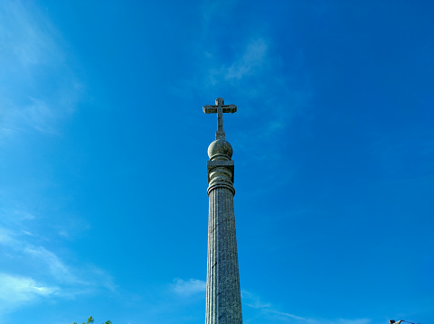 Memorial on top of a mountain with a cross of christ on top of the memorial