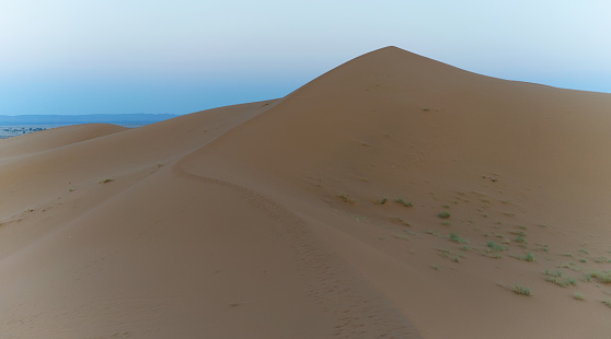 Enormous golden sand dunes before sunrise