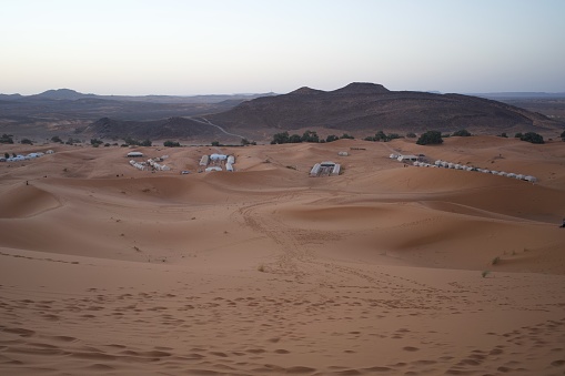 Sand dunes and tents, before the sun rises