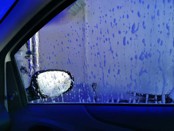 istock Car Care Business. Automatic Car Wash Process. Spray foam bubble shampoo on the car surface. Inside view 1488234154