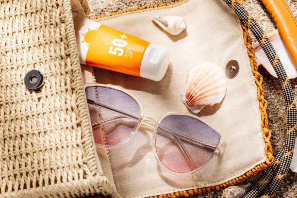 istock Sunscreen and sunglasses in a woven straw bag on a sandy beach 1488237262