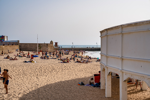 Cadiz, Spain - April 8, 2023: Tourists along the city beach.