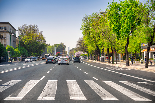 Sevilla, Spain - April 10, 2023: City traffic on a large road,