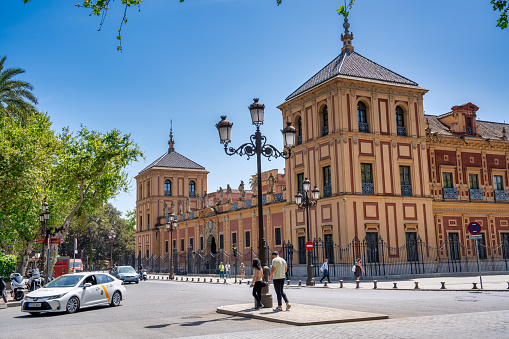 Sevilla, Spain - April 2023: Tourists along Seville Cathedral on a sunny day.