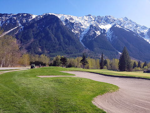 Edge of golf course with sand trap in foreground and spectacular Mt Currie Pemberton BC in Background . An exciting change of scene to explore.