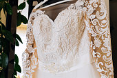 closeup of bride dress with lace and pattern on wardrobe backgro