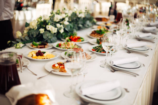 istock table set at a wedding reception decorated with flowers. delicious food and drinks. 1488244306