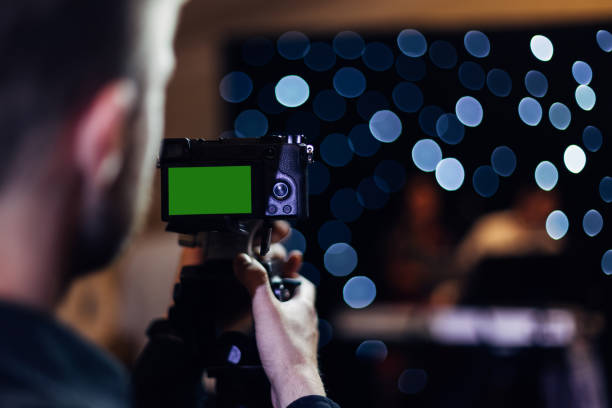 istock professional videographer holds a video camera and a wedding con 1488244388