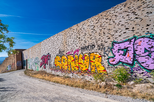 Granada, Spain - April 13, 2023: Mirador de San Miguel Alto wall with graffiti.