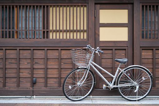 A bicycle park outside a random Japanese wooden house in Takayama, Hida, Gifu, Japan.