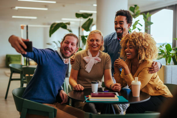 istock Cheerful coworkers taking selfie on coffee break. 1488251350