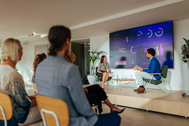 Panel discussion in conference room. stock photo