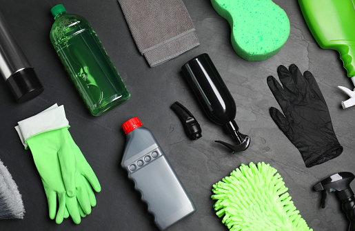 Flat lay composition with car cleaning products on grey table