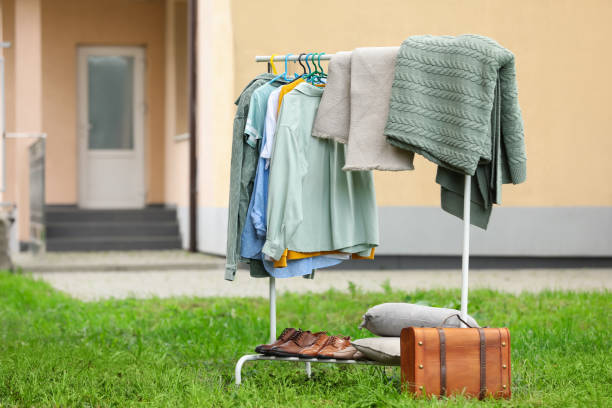 istock Clothing rack with different garments in yard, space for text. Garage sale 1488254145