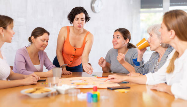istock Women playing board game sitting at table in office 1488256737