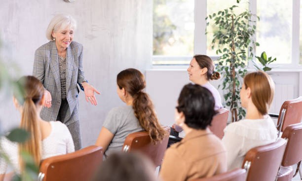 istock Aged female tutor leading educational class for group of women 1488256813