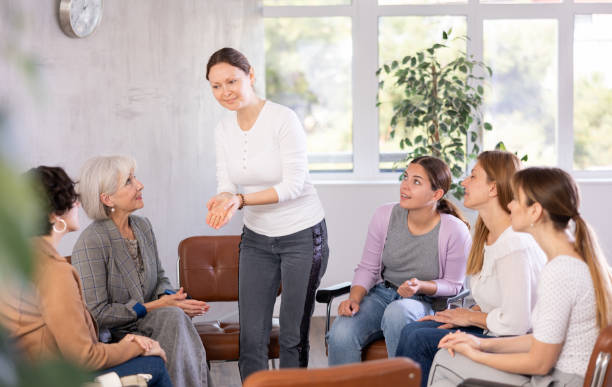 istock Women lead discussion sitting on chairs in circle 1488256825