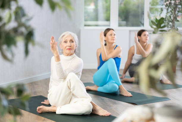 istock European women practice the Ardha Matsyendrasana pose 1488257511
