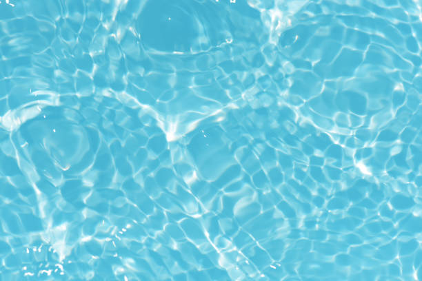 istock Blue water with ripples on the surface. Defocus blurred transparent blue colored clear calm water surface texture with splashes and bubbles. Water waves with shining pattern texture background. 1488259382