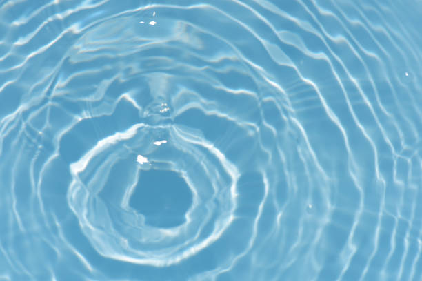 istock Blue water with ripples on the surface. Defocus blurred transparent blue colored clear calm water surface texture with splashes and bubbles. Water waves with shining pattern texture background. 1488259387