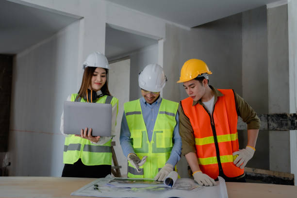 istock multi ethnic engineer brainstorming and measuring for cost estimating on paperworks and floor plan drawings about design architectural and engineering for houses and buildings 1488263092