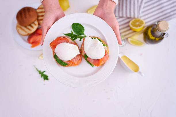 istock Cream cheese, Smoked salmon and poached egg toasts on a plate 1488264409