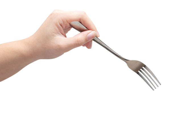 istock isolated of a woman's hand holding a silver fork. 1488266114