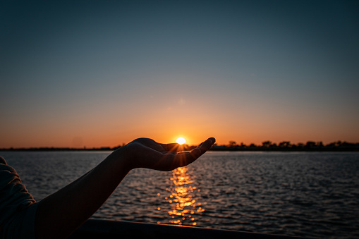 Grasping the Golden Beauty of Sunset in the Palm of Your Hand