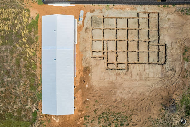 istock Aerial view looking directly down on house construction site: excavated waffle beams ready for reinforced concrete slab 1488273338
