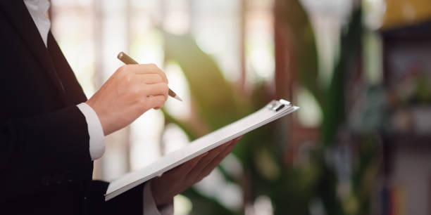 istock business people analyzing market data reports and check the documents ,evaluating the quality and efficiency of personnel ,business document evaluation process,verification of official documents 1488275925