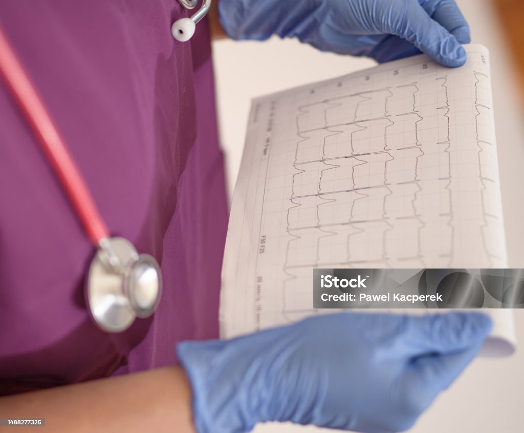 Cardiologist Doctor Analyzing Ekg Test Results Stock Photo - Download ...