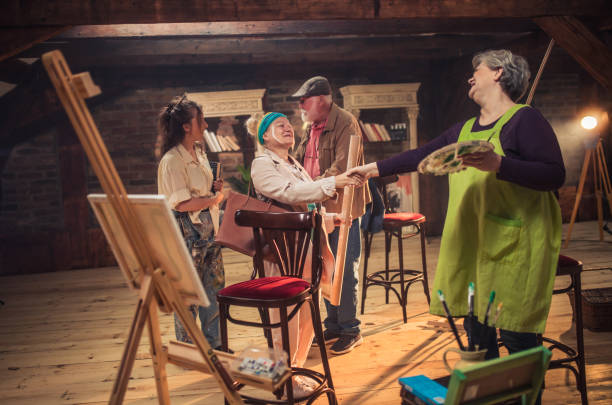 group of seniors attending art class with teacher