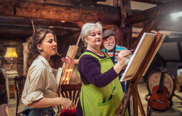 istock group of seniors attending art class with teacher 1488277759