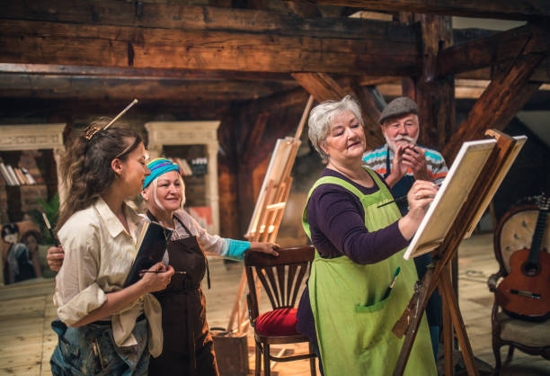 group of seniors attending art class with teacher