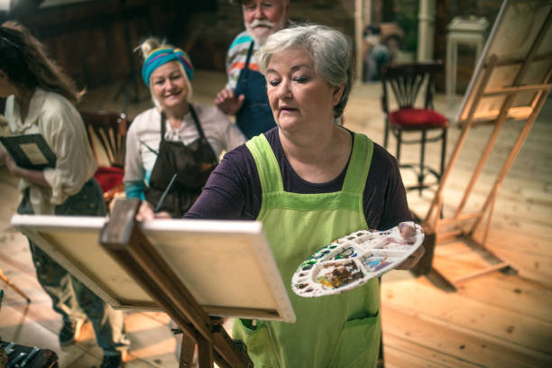 istock group of seniors attending art class with teacher 1488277846