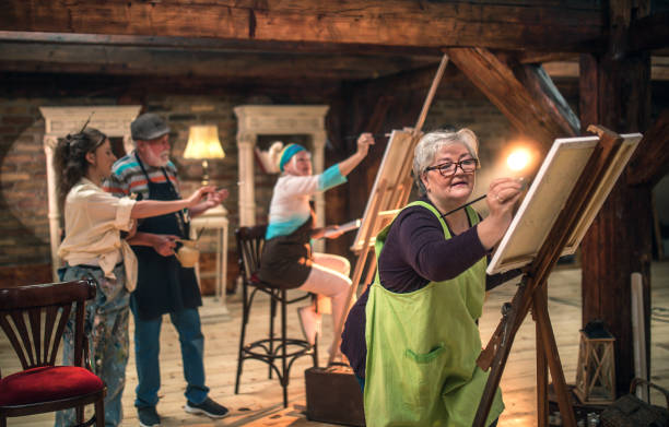 istock group of seniors attending art class with teacher 1488277849