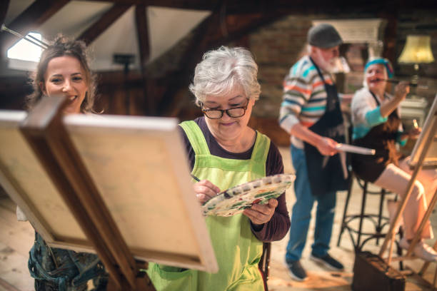 istock group of seniors attending art class with teacher 1488277887