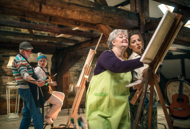 istock group of seniors attending art class with teacher 1488277939
