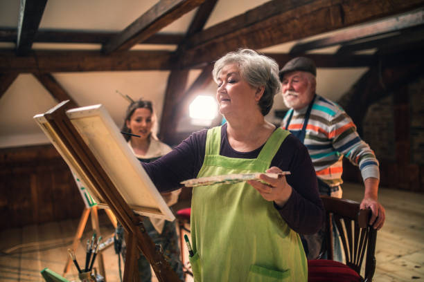 istock group of seniors attending art class with teacher 1488277978