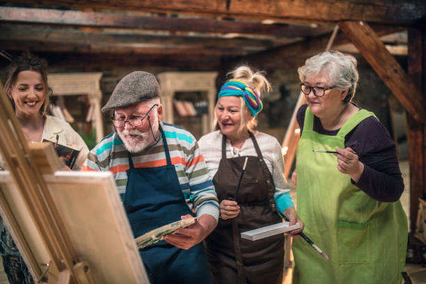 istock group of seniors attending art class with teacher 1488278012
