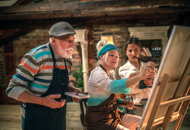 istock group of seniors attending art class with teacher 1488278572