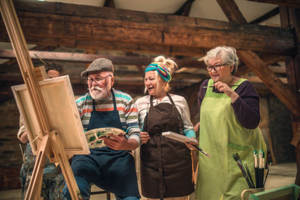 istock group of seniors attending art class with teacher 1488278616