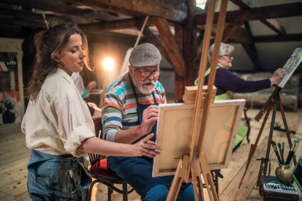istock group of seniors attending art class with teacher 1488278735
