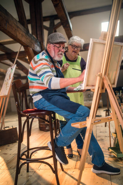 istock group of seniors attending art class with teacher 1488278738