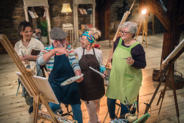 group of seniors attending art class with teacher