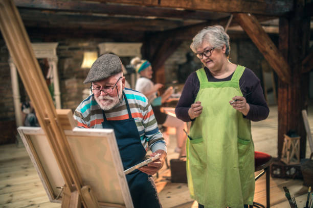 istock group of seniors attending art class with teacher 1488278896