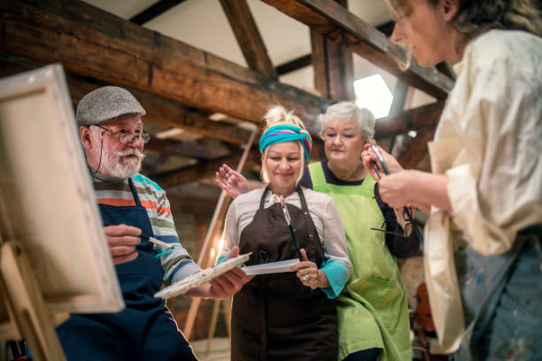 istock group of seniors attending art class with teacher 1488279031